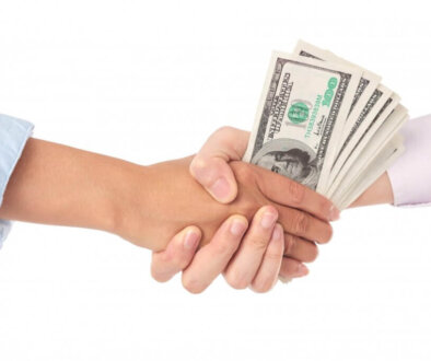 closeup-handshake-with-dollar-bills-middle_1098-19706