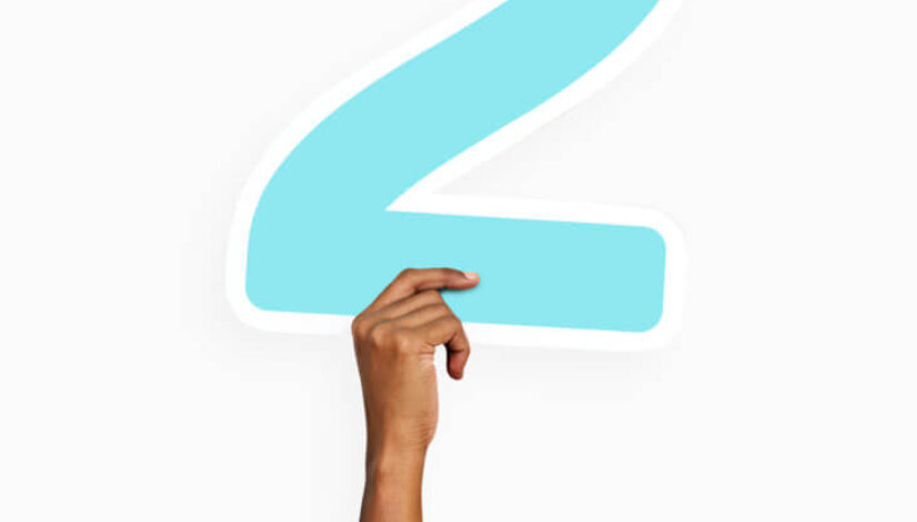 Hand holding number two sign