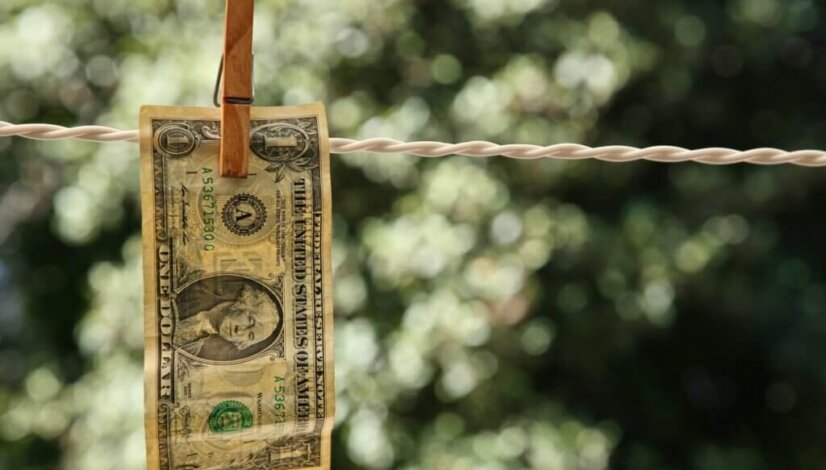 selective-focus-shot-dollar-bill-hung-from-wire-with-clothespin_181624-9172