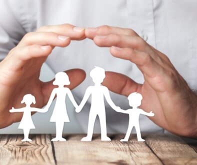Protecting Hands Over Paper Family / Family Protection And Care Concept